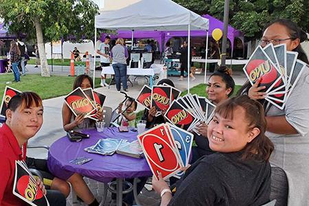 Students at outside table playing with giant UNO cards